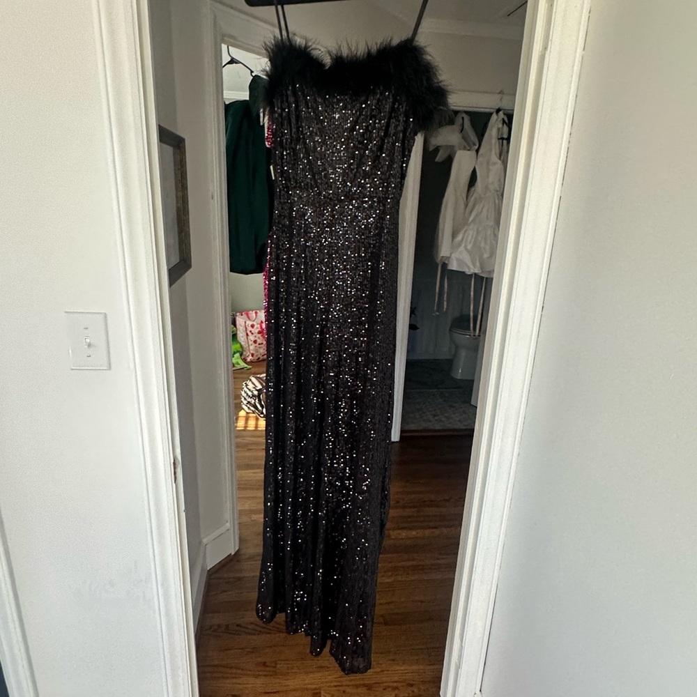 Black sequin jumpsuit with fur trim. Only worn once.